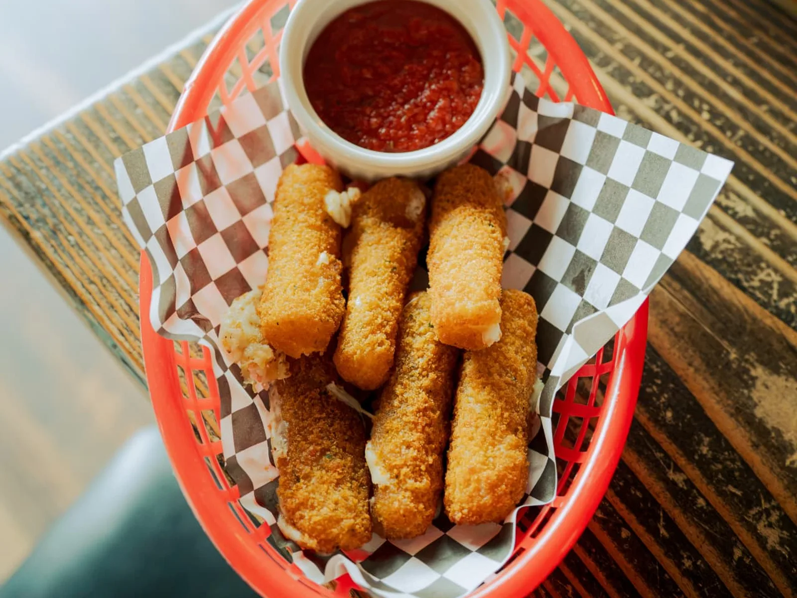 Basket of mozzarella sticks with marinara dipping sauce